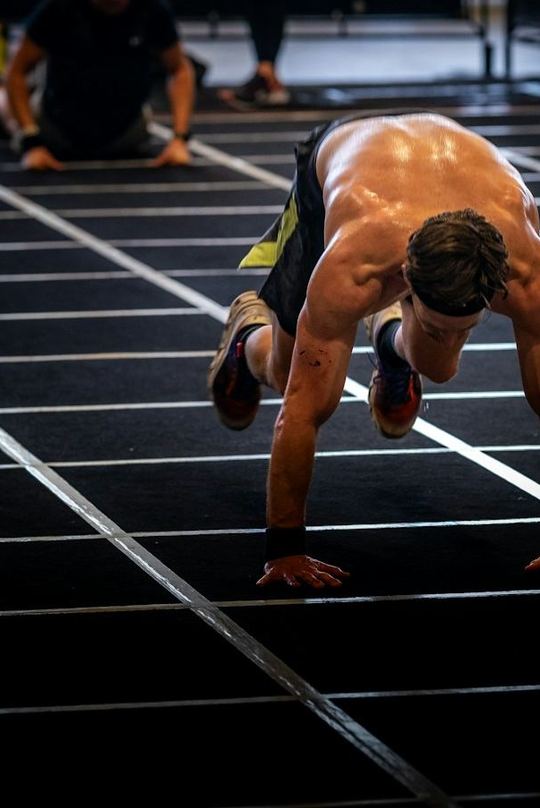 A burpee broad jump down a marked lane