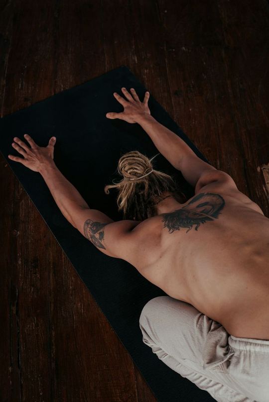 An extended reach on a mat, shot from above